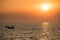 fisherman sailing boat on sea at sunset, Bang Pu