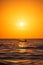 Fisherman sailing with his boat on beautiful sunrise over the sea