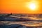 Fisherman sailing with his boat on beautiful sunrise over the sea