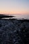 Fisherman by the sea at sunset. twilight silhouettes of people in the distance