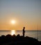 fisherman shadow on the rocks of Punta Ballena coastline on the bay of Solanas, atlantic ocean, Maldonado, Uruguay