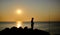 fisherman shadow on the rocks of Punta Ballena coastline on the bay of Solanas, atlantic ocean, Maldonado, Uruguay