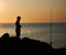fisherman shadow on the rocks of Punta Ballena coastline on the bay of Solanas, atlantic ocean, Maldonado, Uruguay