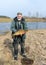 A fisherman on the shore of a lake, carp caught in the hands of a fisherman, amateur carp fishing, fishing as a hobby