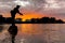 A fisherman silhouette fishing at sunset