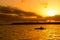 Fisherman silhouette in kayak and lake sunset