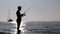 Fisherman silhouette at Ria Formosa wetlands, Algarve, Portugal.