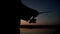 Fisherman silhouette spinning fishing reel on background evening sunset