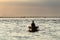 Fisherman silhouette at Sunset in Venice lagoon chioggia harbor from a boat