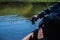 Fisherman sits in a boat with a small winter fishing rod on the river