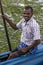 A fisherman sits in his pontoon boat prior to taking a group of tourists for a trip on Pottuvil Lagoon.