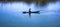 A fisherman sits on the little boat in the middle of river, local agriculture.