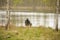 Fisherman sits on the seat on the coast of lake