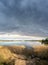 Fisherman sits on the shores of a lake and fishes at a spring sunset