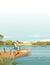 Fisherman sits on wooden pier and fishing with rod vector illustration vertical format