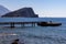 Fisherman sitting on the end of a pier