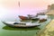 Fisherman sitting and fishing from colorful wooden boats in the morning mist on the holy rive Ganges at Varanasi