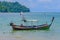 A fisherman sitting in his long tail boat