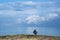 Fisherman sitting relaxed with a blue sky