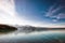 Fisherman in a small boat on a beautiful pristine Alaskan Lake during summer