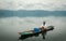 Fisherman in a small boat with his traps on the biggest lake in