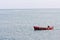 Fisherman in a small fishing boat off Howth harbour in Ireland