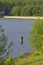A Fisherman standing in the water of the Fewston Reservoir in West Yorkshire