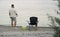 fisherman stands on the lake shore and fishing. Fishing hobby vacation concept.