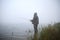 Fisherman stands in the water on the lake