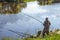 Fisherman on a summer day fishing on the river on a float