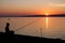 Fisherman and sunset over Lake