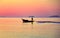 A fisherman takes a small local fishing boat out to fish early in the morning at sea, Rayong Province, Thailand