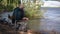 Fisherman throws a hook into the river and carefully monitors