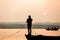 Fisherman throws net in the sunrise on Ganges river, Varanasi