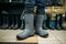 Fisherman tries on rubber boots in fishing shop