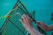 Fisherman try to unpack trapped fish from fishing net with background of blue sea