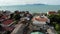 Fisherman village on seashore. Aerial view of typical touristic place on Ko Samui island with souvenir shops and walking street on