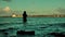 Fisherman in water at sunset, Laboe coastline, Kiel