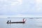 Fisherman on wooden boat catch jellyfish in sea