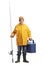 Fisherman in a yellow raincoat holding a portable freezer and a fishing rod