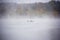 Fishermans in boats fishing in big misty fog