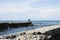 Fishermans with fishing rod on the pier in front of the sea