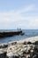 Fishermans with fishing rod on the pier in front of the sea