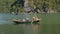 Fishermen in the boat at Ha Long Bay