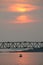 Fishermen and boats mask the harbor after sunset