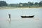 The fishermen are busy in catching fish in the river in the river Damodar.