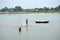 The fishermen are busy in catching fish in the river in the river Damodar.