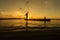 Fishermen and children fishing in the river a golden color silhouette