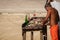 Fishermen cleaning and filleting fresh caught fish on the beach in Belize, Central America.