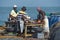 Fishermen cleaning fish for drying.